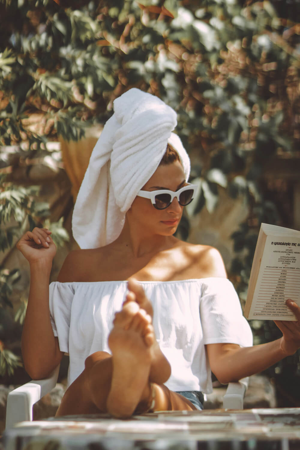 Woman reading a book by the pool at Leland South Congress